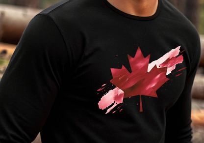 On the front of this unisex long sleeve shirt is an image of a Canadian maple leaf that is bright red, it looks like it has been spray painted onto the front of the shirt.