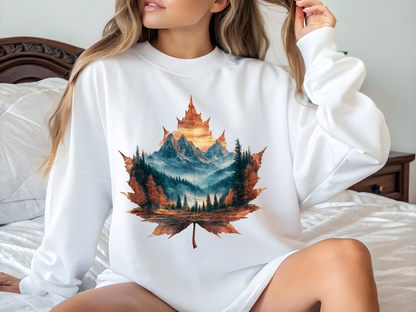 On the front of this Canadian pride sweatshirt is a large maple leaf with the inside of the leaf having a picture of the Rocky Mountains in the fall time.