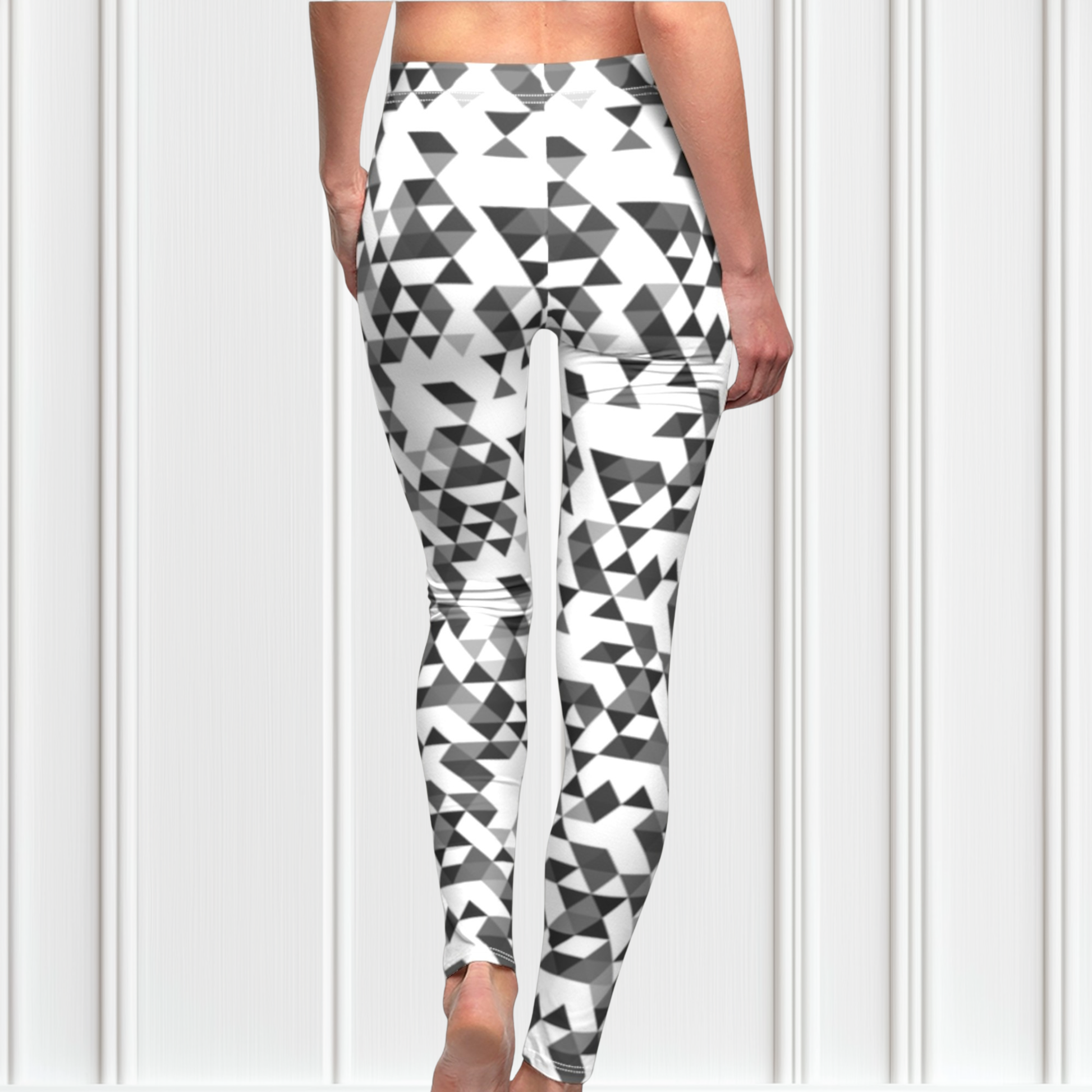 A  pair of women's handmade custom high waisted leggings, the leggings have a black, grey and white geometric pattern all across the entire pair of workout leggings.