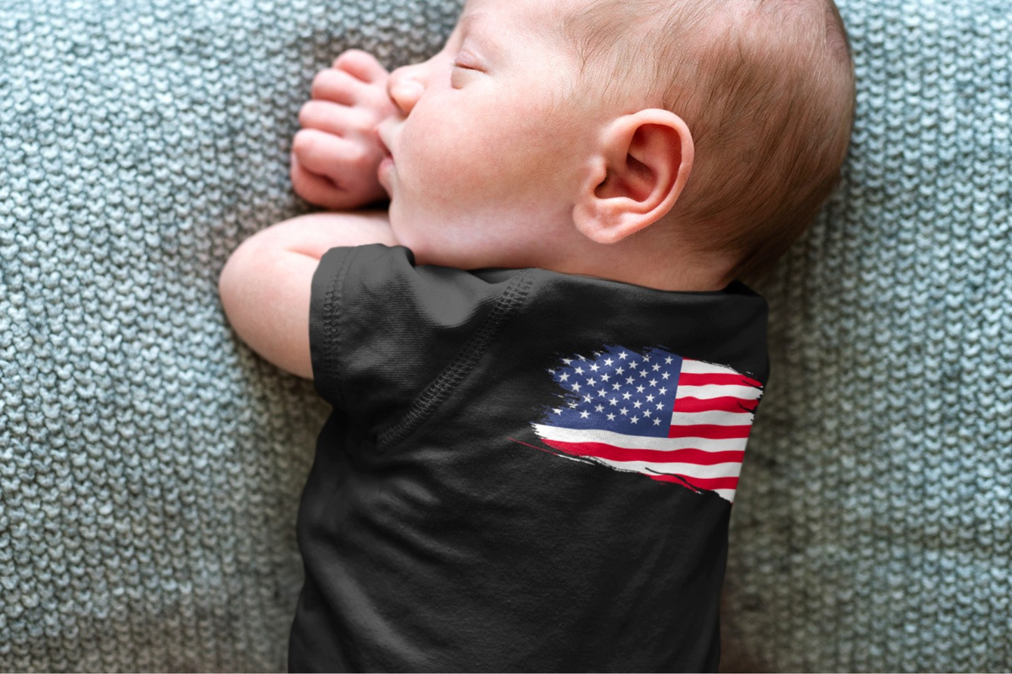On the front of this custom baby onesie are the words Made In America in a rectangular box that makes it look like a stamp, on the back of this bodysuit is the American flag.
