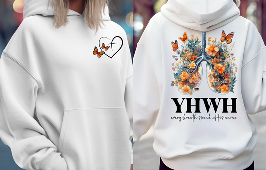 On the front of this custom women's Christian hoodie is a large heart that has a Jesus cross in the center of it, there are two butterflies around the heart. On the back of the sweater is an image of a pair of human lungs made from flowers and butterflies, under the image it says YHWH every breath speaks His name.