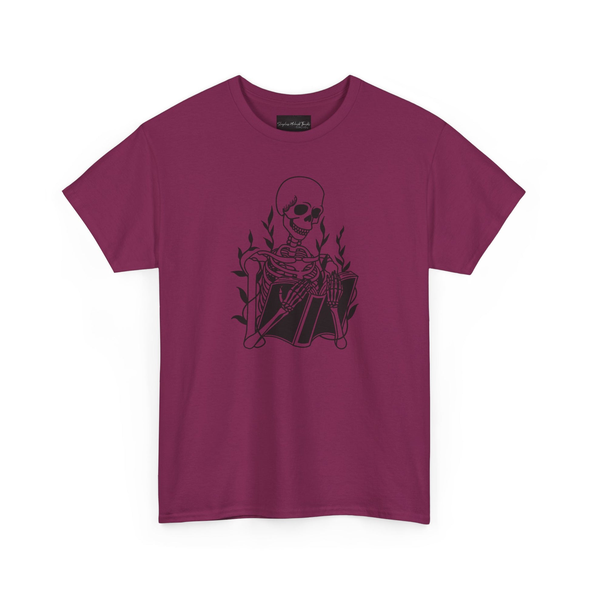 On the front of this custom unisex short sleeve shirt is a large image of a skeleton reading a book, there are vines with leaves on them behind the skeleton.