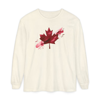 On the front of this unisex long sleeve shirt is an image of a Canadian maple leaf that is bright red, it looks like it has been spray painted onto the front of the shirt.