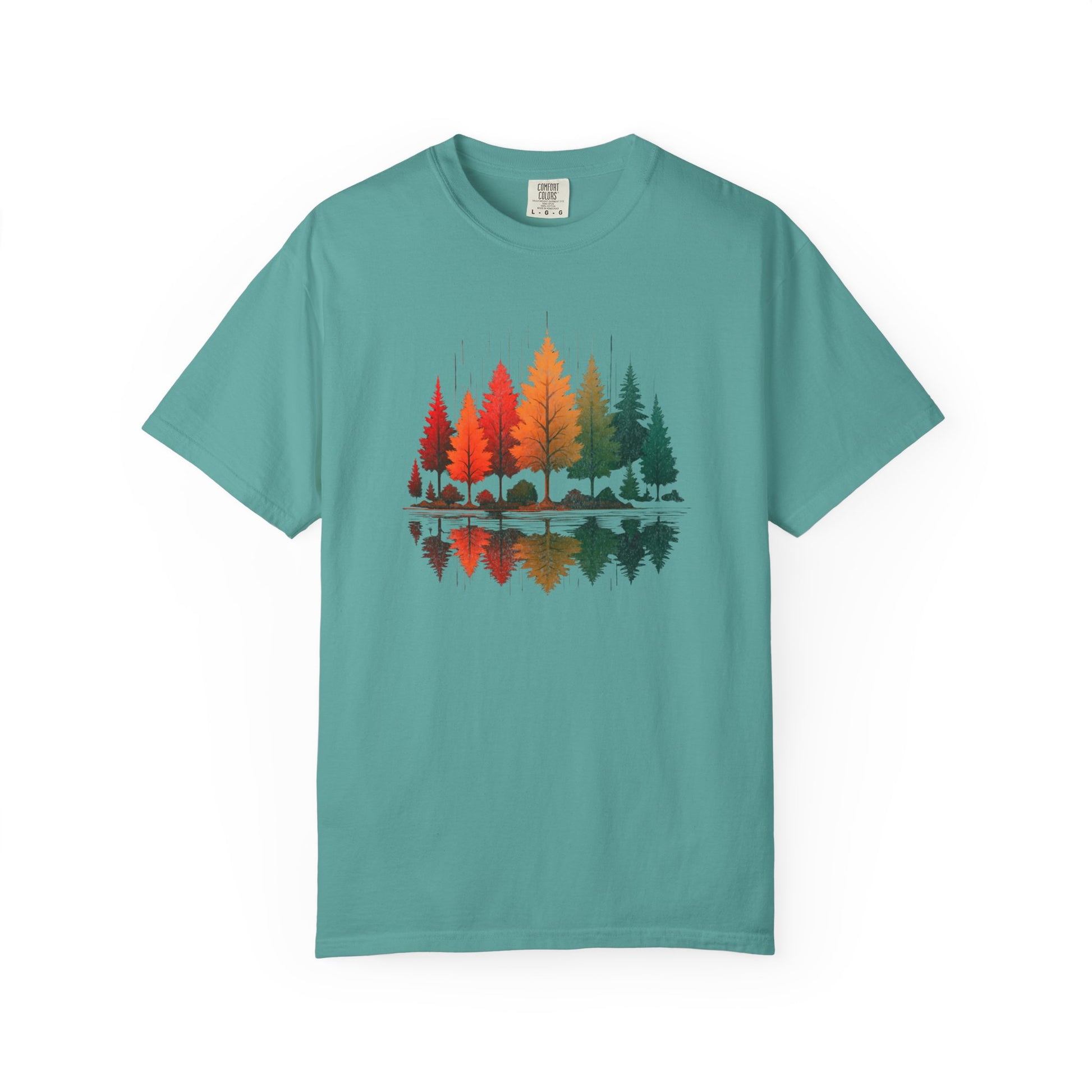 On the front of this custom comfort colors short sleeve shirt is a image of trees in the fall time with all the different fall colors, the trees reflection is right underneath making them look like they are above water.