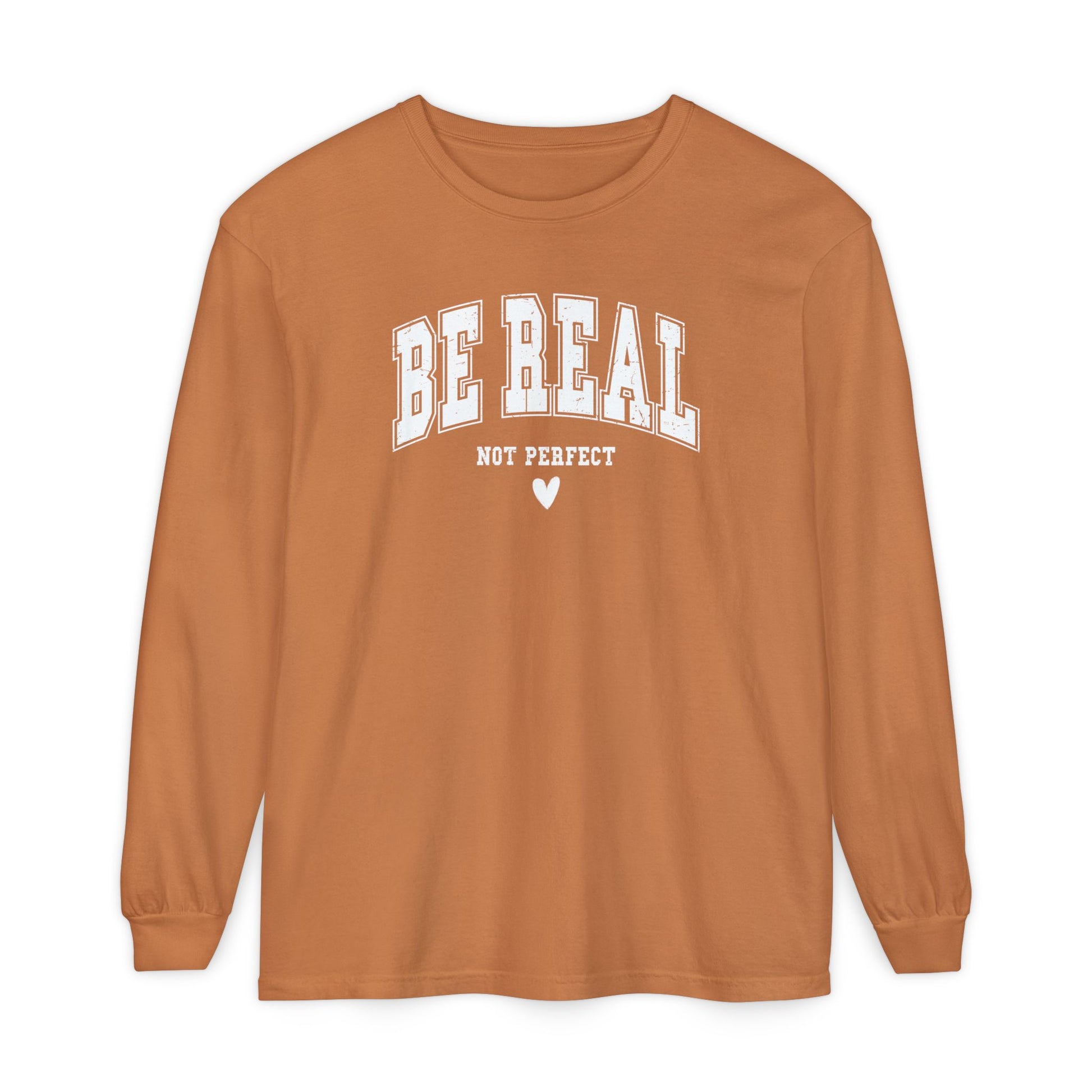 On the front of this custom unisex long sleeve shirt are the words Be Real in large bubble font with the words not perfect underneath the bubble letters, on the bottom there is a heart.