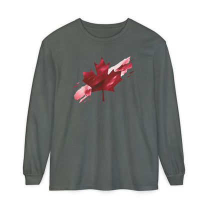 On the front of this unisex long sleeve shirt is an image of a Canadian maple leaf that is bright red, it looks like it has been spray painted onto the front of the shirt.