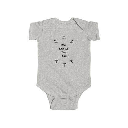 on the front of this custom infant onesie specifically meant for dads, are the words You can do this dad with arrows pointing where each leg and each arm goes along with were the babies head goes and where to close the snaps, a perfect diagram for a new father on how to put a onesie on a baby.