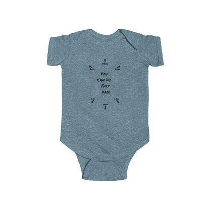 on the front of this custom infant onesie specifically meant for dads, are the words You can do this dad with arrows pointing where each leg and each arm goes along with were the babies head goes and where to close the snaps, a perfect diagram for a new father on how to put a onesie on a baby.