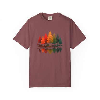 On the front of this custom comfort colors short sleeve shirt is a image of trees in the fall time with all the different fall colors, the trees reflection is right underneath making them look like they are above water.