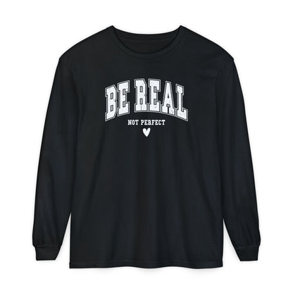 On the front of this custom unisex long sleeve shirt are the words Be Real in large bubble font with the words not perfect underneath the bubble letters, on the bottom there is a heart.