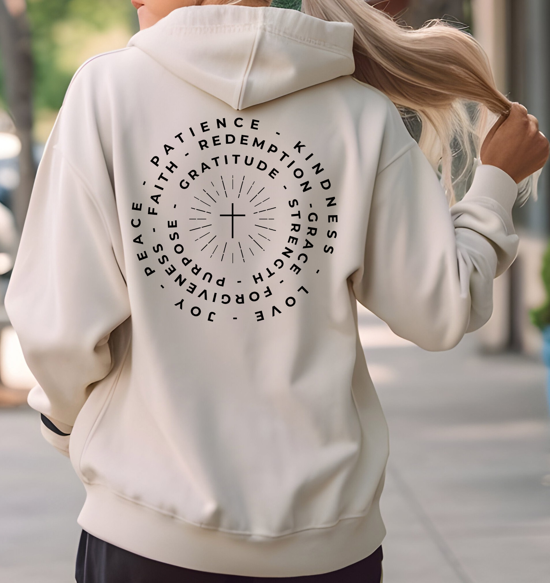 This custom Christian hoodie features a unique design on the back with a centered cross surrounded by circles of words such as Gratitude, Redemption, Patience, Joy, Love, Kindness, Peace, Faith, Forgiveness, Grace, Purpose and Strength.