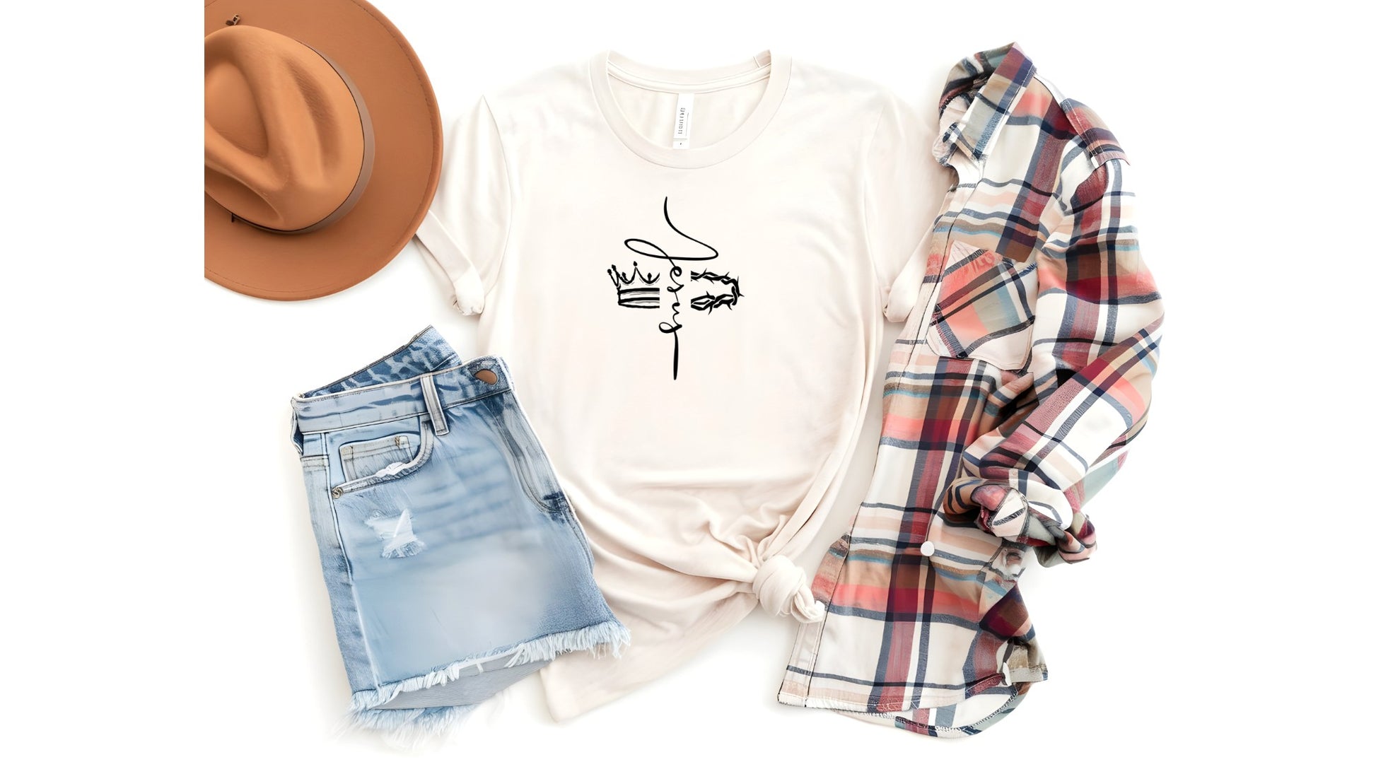 On the front of this custom Christian t-shirt is the name of Jesus in a cursive front from the top of the shirt facing towards the bottom, there is a crown on one side of the name and a crown of thorns on the other side of the name.