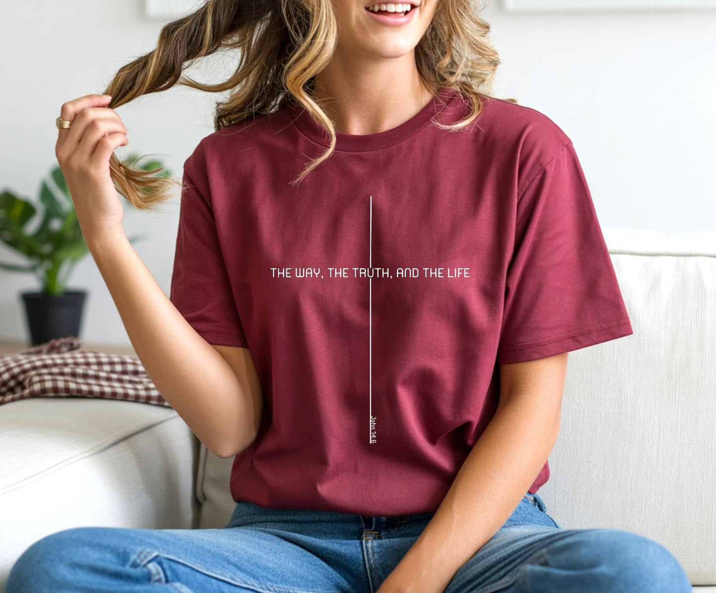 On the front of this custom faith inspired handmade t-shirt is a cross with the bible verse The Way, The Truth, and The Life John 14:6 in a modern font.