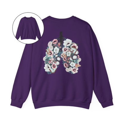 On the back of this women's pullover sweatshirt is an image of a set of lungs, but the lungs are made out of vines with pink and white flowers all over them, there are butterflies sitting in top of the flowers that are light blue in color.