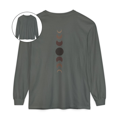 On the back of this custom unisex long sleeve t-shirt from the top of the shirt to the bottom are 7 images of the moon showing the moons cycle, every moon is a different shade of brown.