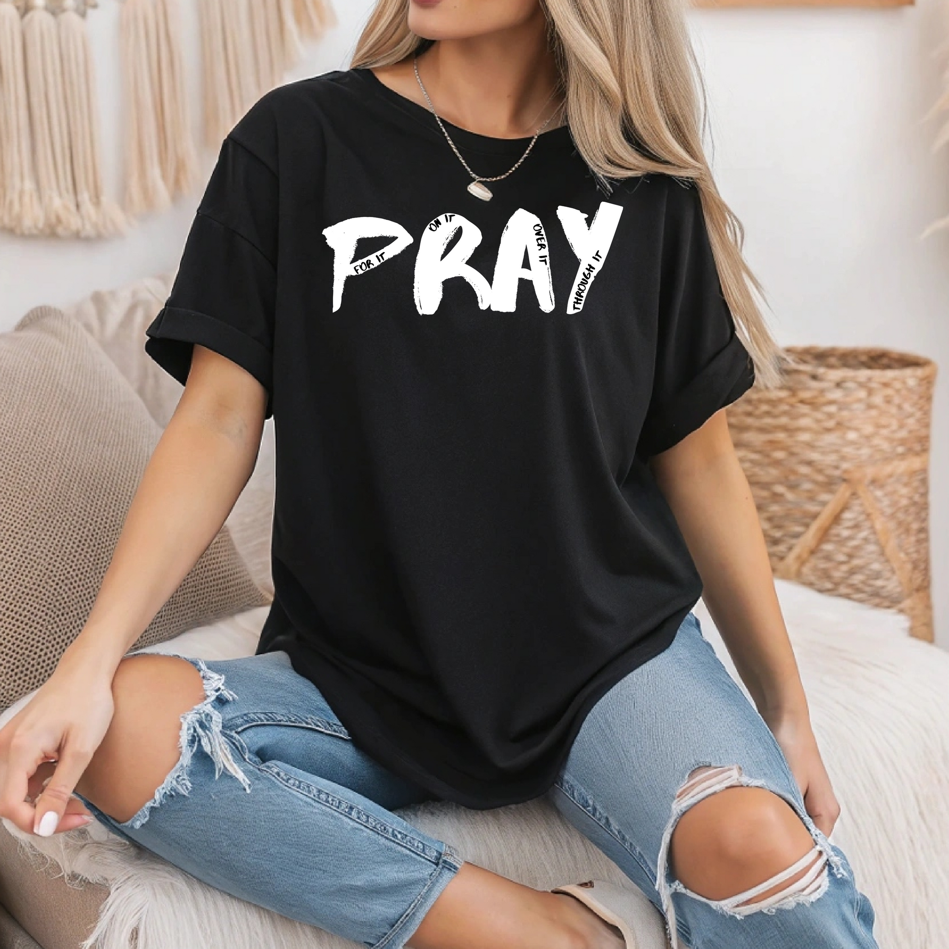 On the front of this custom handmade short sleeve shirt is the word pray in large black lettering, inside each letter in smaller writing are the words For it On it Over it and Through it in a different color font.
