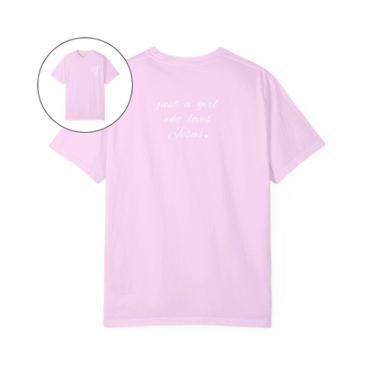 On the front of this custom women's Christian t-shirt is a heart with a cross through it, on the back top of the shirt right between the shoulder blades are the words just a girl who loves Jesus in a cursive writing.