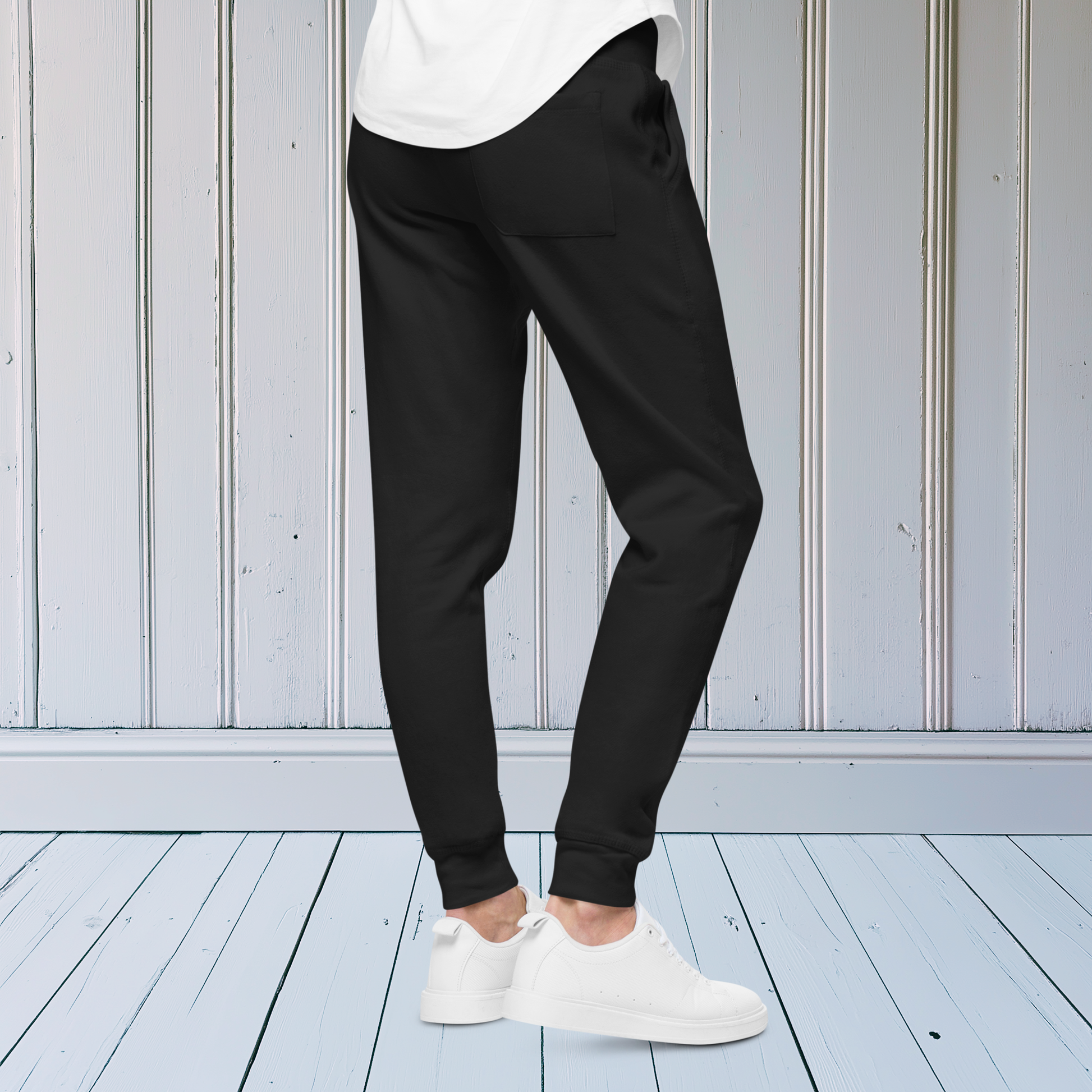 A pair of super soft ankle length unisex sweatpants, there are two pockets on the front and one pocket on the back right. There is a red heart with an exclamation point next to it embroidered on the front left pocket.