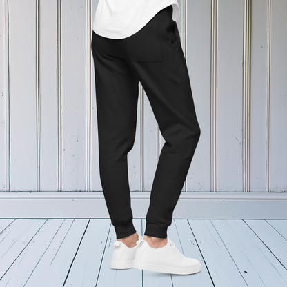 A pair of super soft ankle length unisex sweatpants, there are two pockets on the front and one pocket on the back right. There is a red heart with an exclamation point next to it embroidered on the front left pocket.