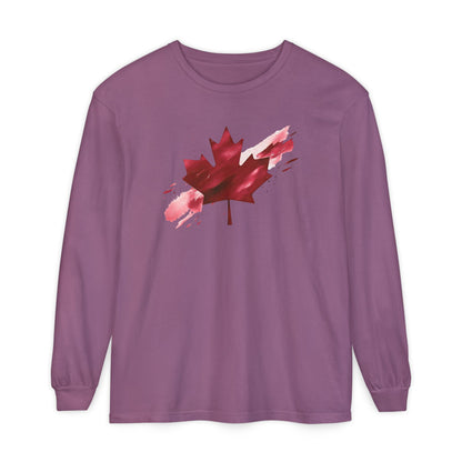 On the front of this unisex long sleeve shirt is an image of a Canadian maple leaf that is bright red, it looks like it has been spray painted onto the front of the shirt.