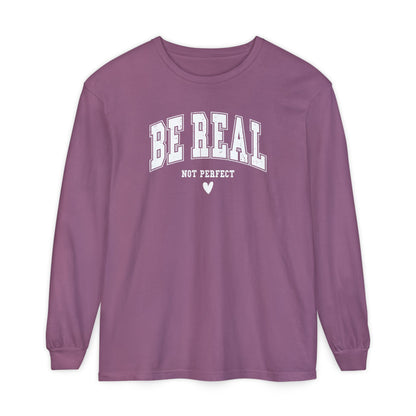 On the front of this custom unisex long sleeve shirt are the words Be Real in large bubble font with the words not perfect underneath the bubble letters, on the bottom there is a heart.