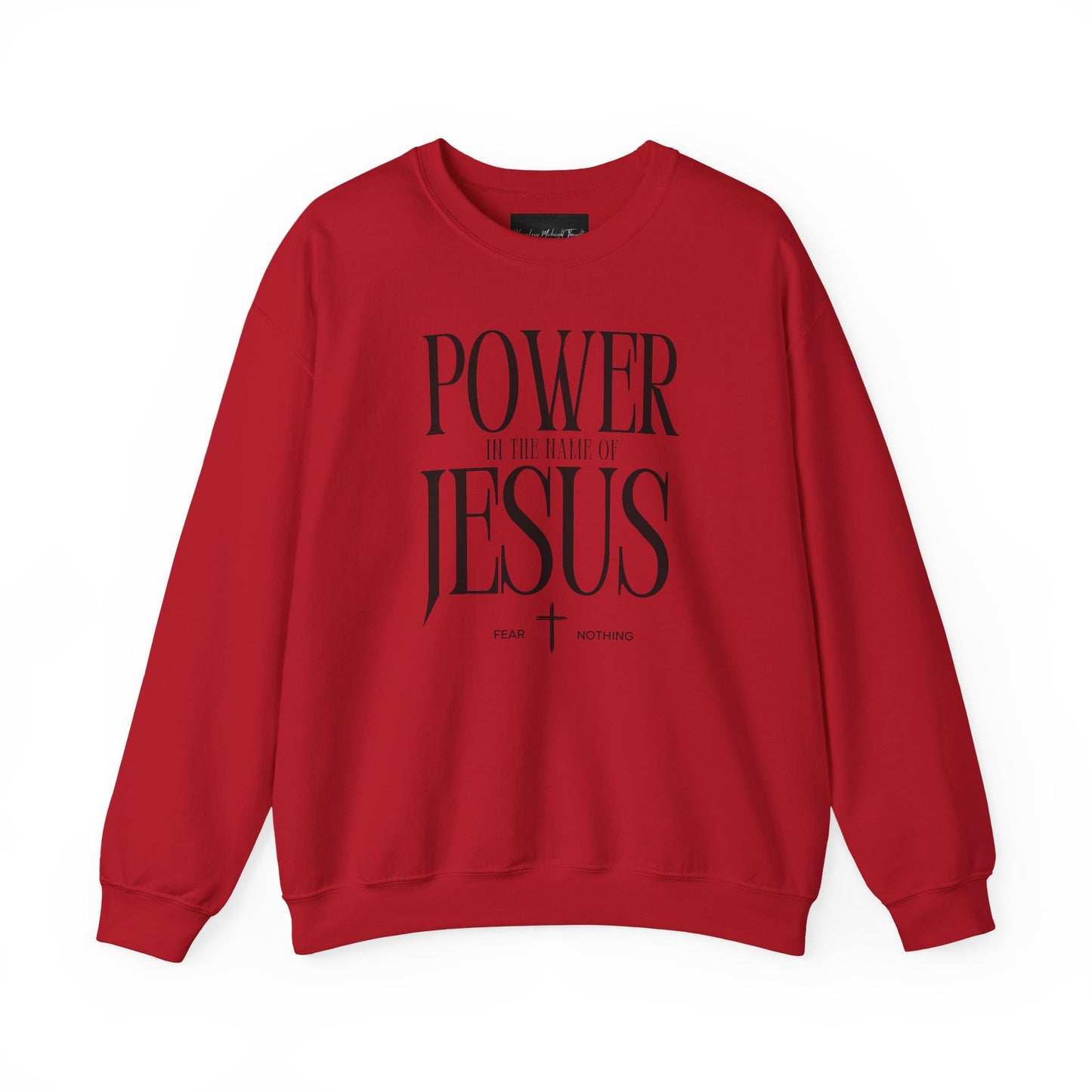 On the front of this Christian pullover sweatshirt it says Power In The Name Of Jesus with a Jesus cross underneath it, on either side of the cross are the words Fear and Nothing.