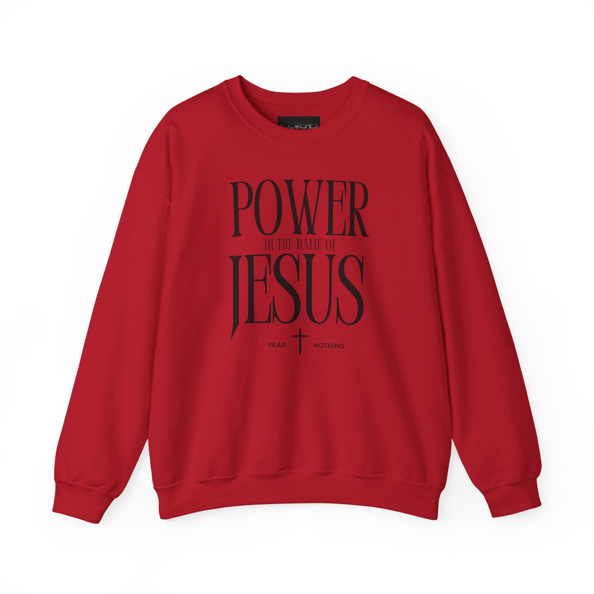 On the front of this Christian pullover sweatshirt it says Power In The Name Of Jesus with a Jesus cross underneath it, on either side of the cross are the words Fear and Nothing.