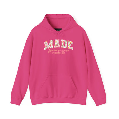 On the front of this custom Christian hoodie is the bible verse the says Made for more Ephesians 2:10, with the word "Made" being large block letters with a pink floral pattern inside the letters, all the other words are in a light pink color.