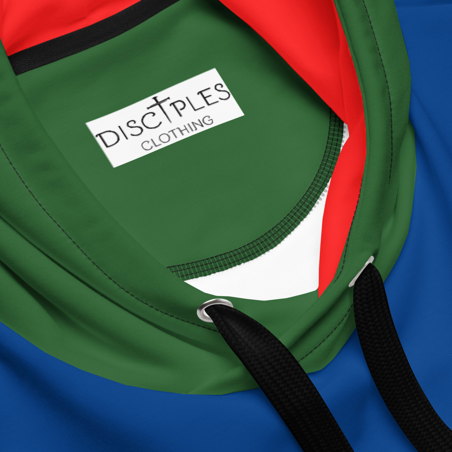 A custom hand sewn hoodie that has a color block design with the front and the back of the hoodie being a bright blue color, the front pocket and the outside of the hood are green, the inside of the hood and the sleeves are red in color with the cuffs of the sleeves and the waistband being a bright yellow color.