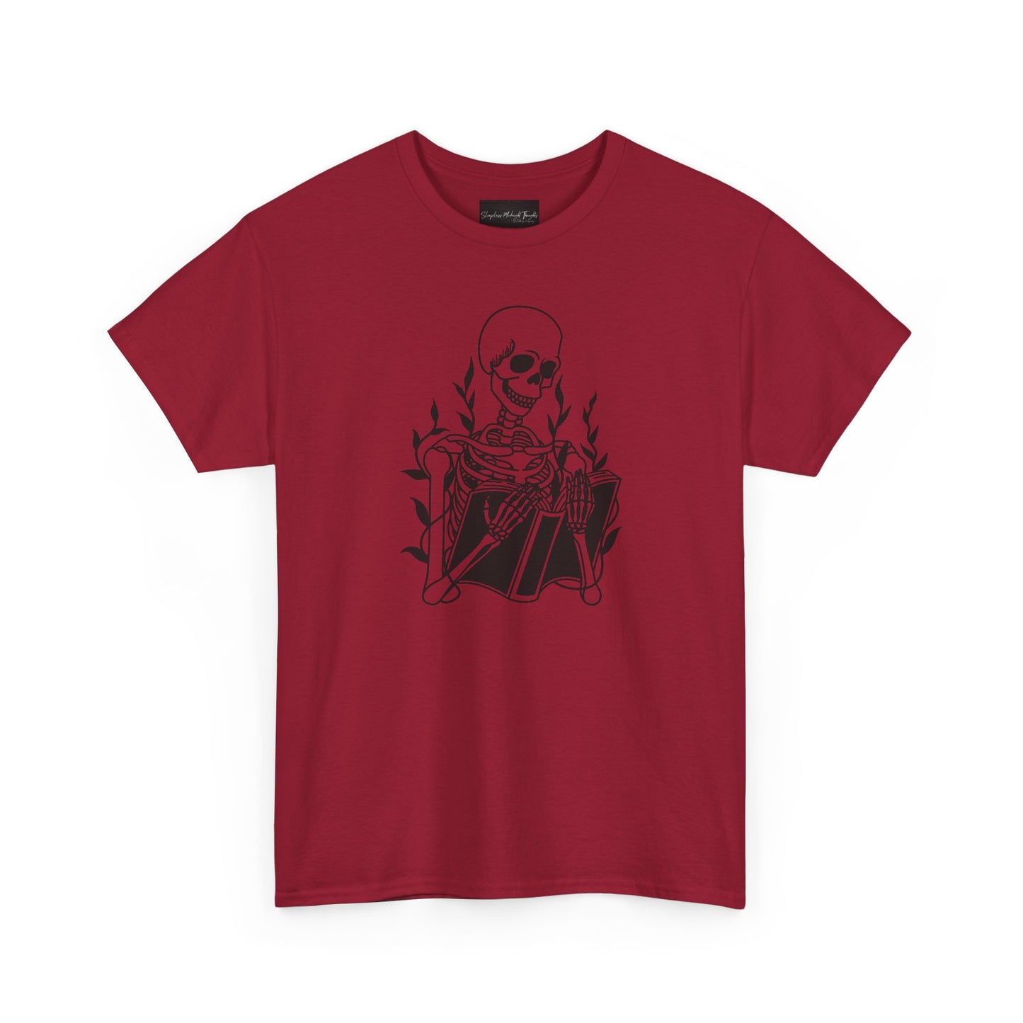 On the front of this custom unisex short sleeve shirt is a large image of a skeleton reading a book, there are vines with leaves on them behind the skeleton.