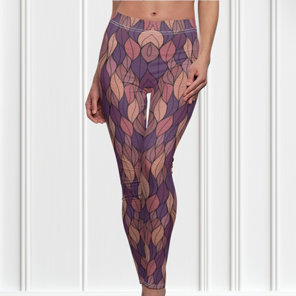 These custom colorful handmade women's leggings have a pattern of multicolored leaves from top to bottom, the leaves are light pink, purple, mauve and beige giving the leggings a vibrant look.