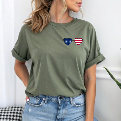 This super soft unisex t-shirt has a image of a pair of heart shaped sunglasses over the front left chest of the shirt, the American flag is inside the sunglasses. Perfect for 4th of July celebrations.