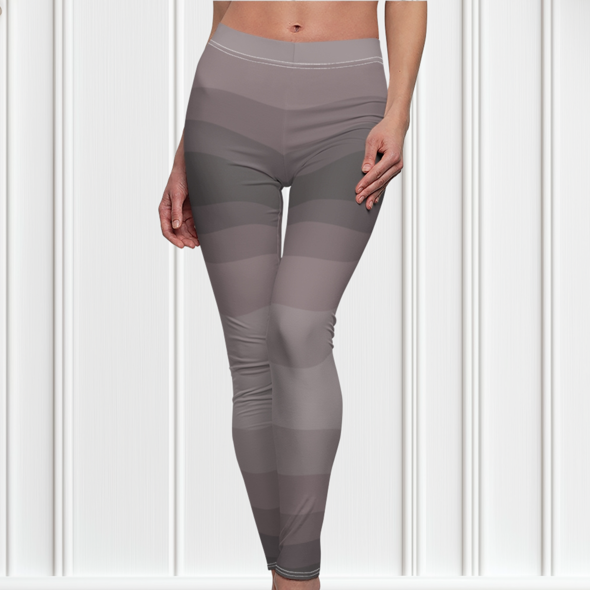 Custom high waisted women's leggings that have a wavy lines pattern that are all different shades of grey.