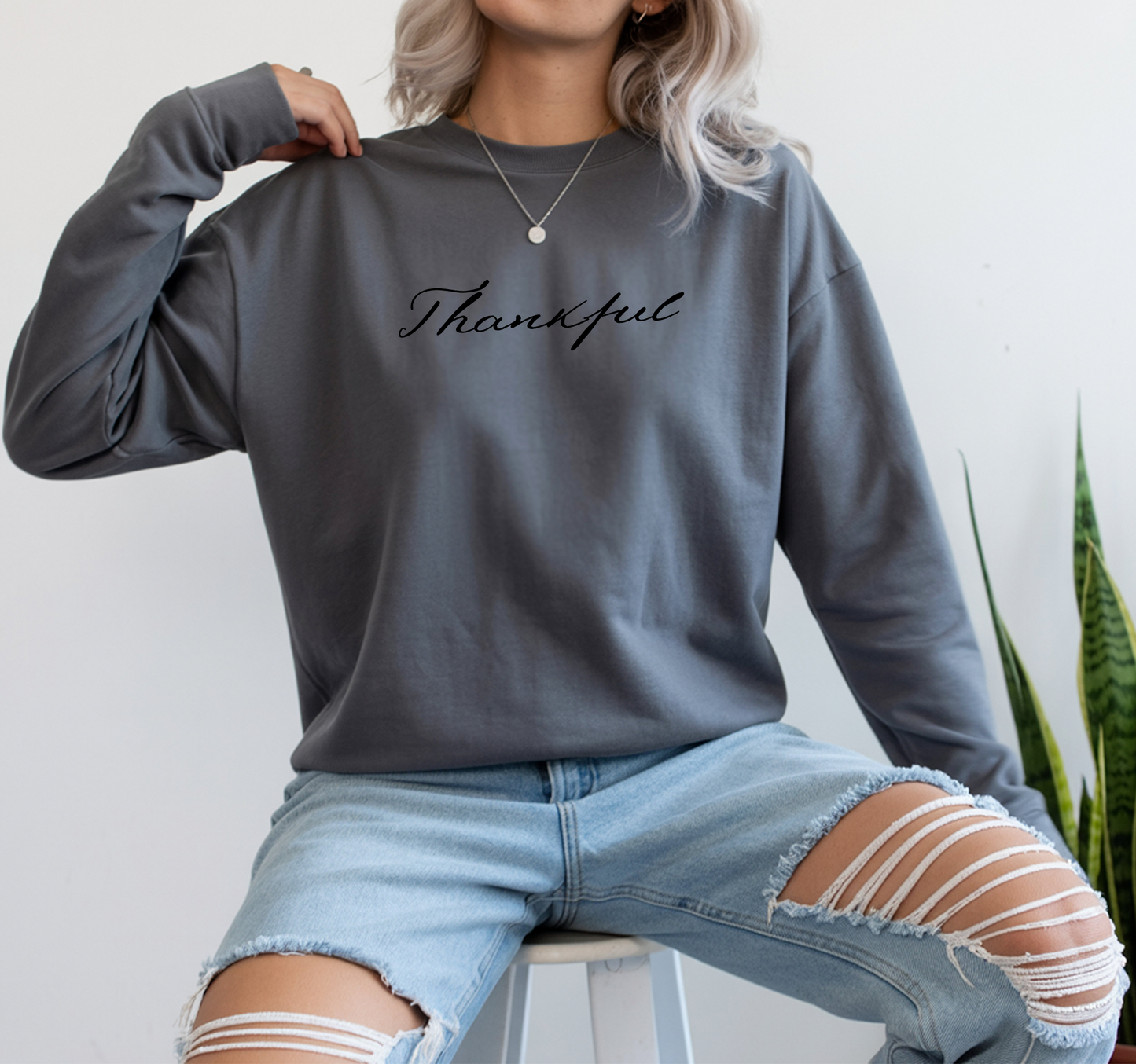On the front of this custom unisex long sleeve t-shirt is the word thankful in a flowy cursive font.