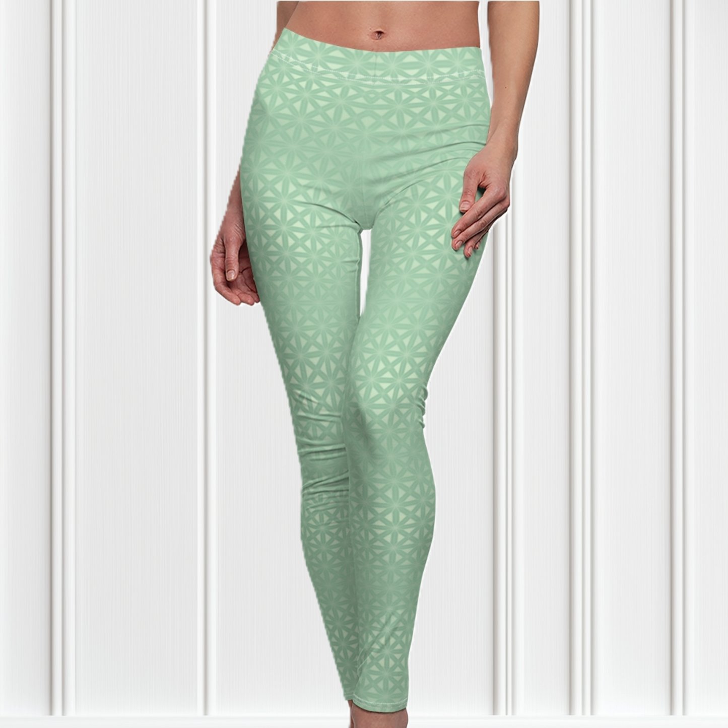 These high waisted women's leggings are a light green with a geometric pattern overlayed overtop, some spots are brighter than others showcasing some spots more than others.