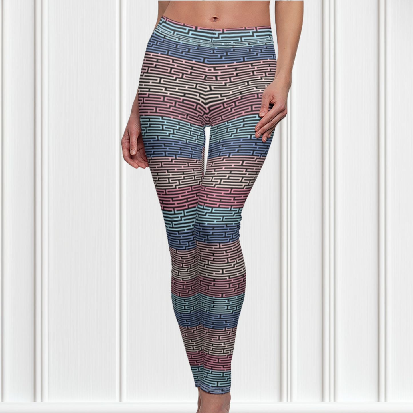 Custom women's high waisted leggings with rows of pastel red, yellow and blue from the top to the bottom of the leggings, there is a black abstract pattern overtop of the colors giving the leggings a 3D look.