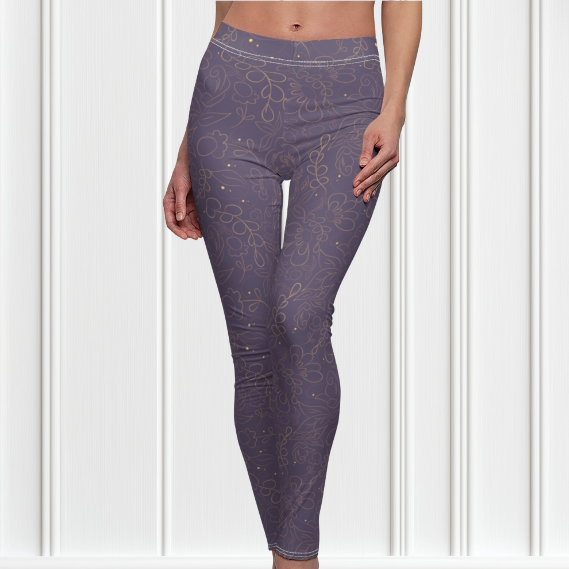 These custom handmade women's leggings are a dark purple with a beautiful gold floral pattern overlayed on the top.