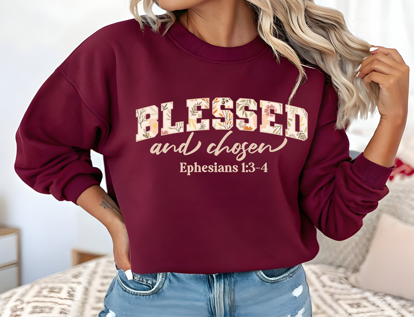 On the front of this custom Christian sweatshirt is the bible verse Blessed and Chosen Ephesians 1:3-4 with the word Blessed being in large bubble letters with a floral pattern on the inside of the letters.