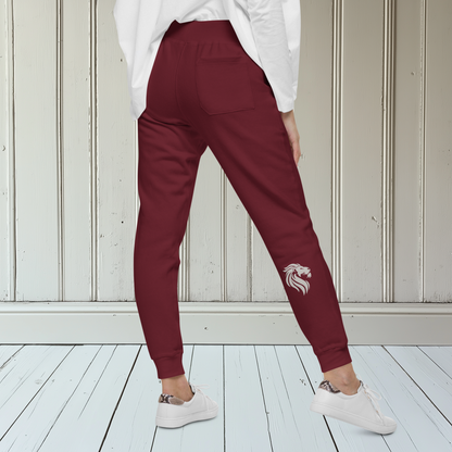 A pair of super soft custom unisex fleece sweatpants with a male lion head on the back calf of the right leg embroidered in silver.