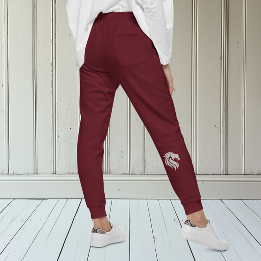 A pair of super soft custom unisex fleece sweatpants with a male lion head on the back calf of the right leg embroidered in silver.
