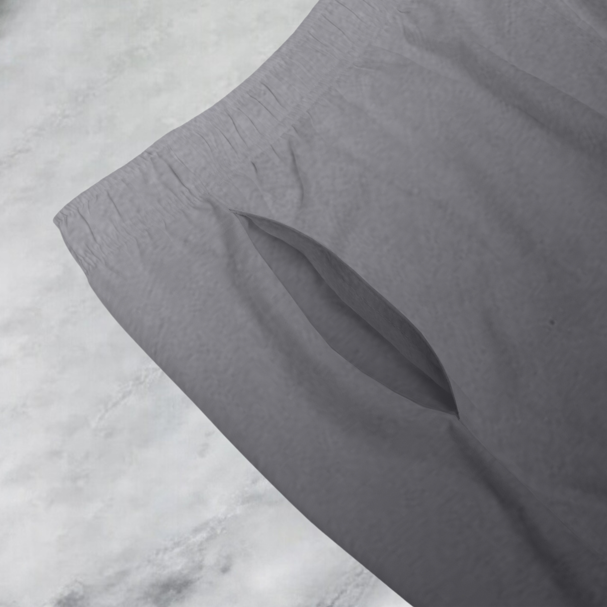 These custom men's board shorts feature a unique design with a ombre pattern starting with a light grey at the top then fading to a dark grey at the bottom, there is a symbol of a dove carrying a fig leaf on the front left side of the shorts just at the knee.