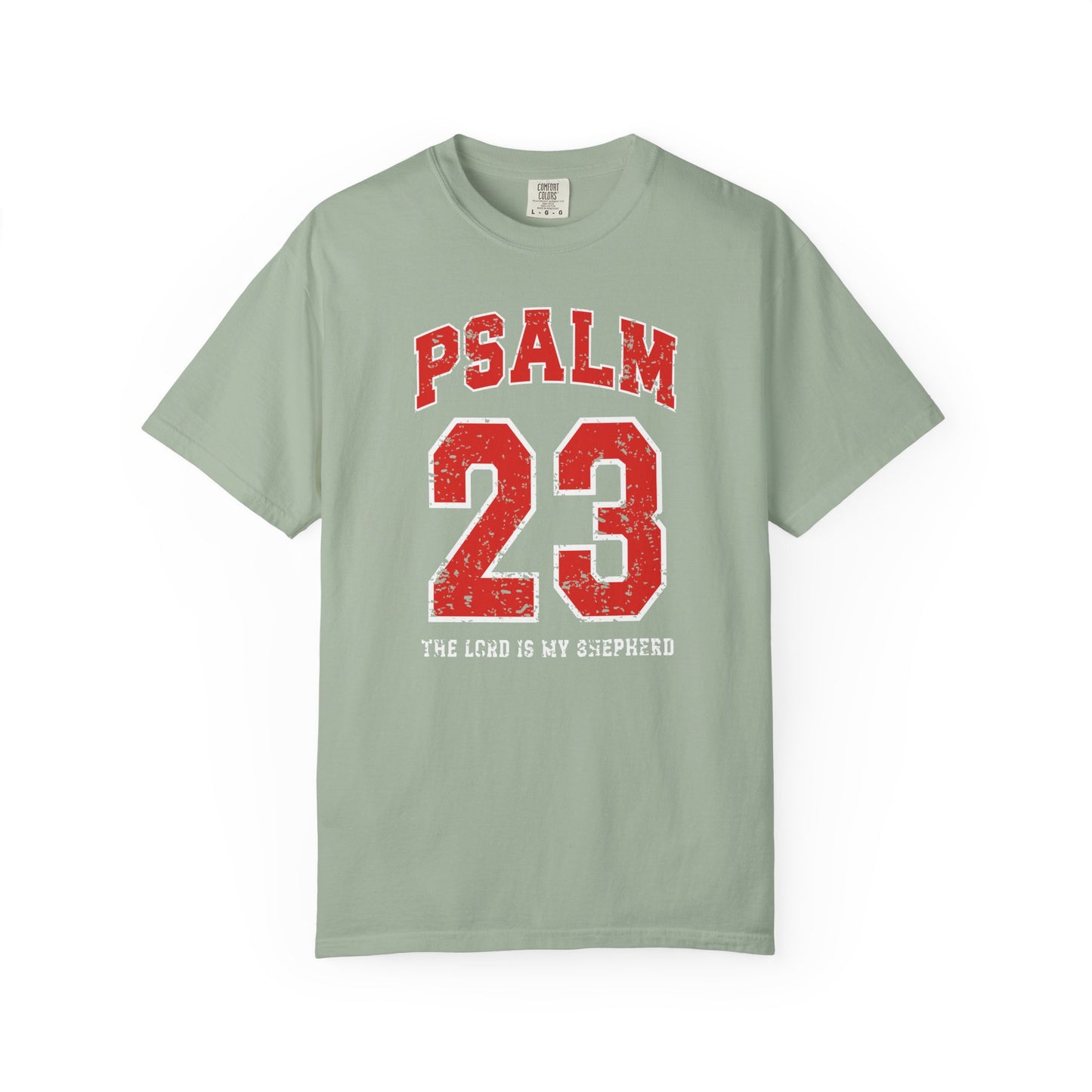 On the front side of this custom vintage t-shirt are the words Psalm 23 The Lord Is My Shepherd, it is with red and white block lettering.