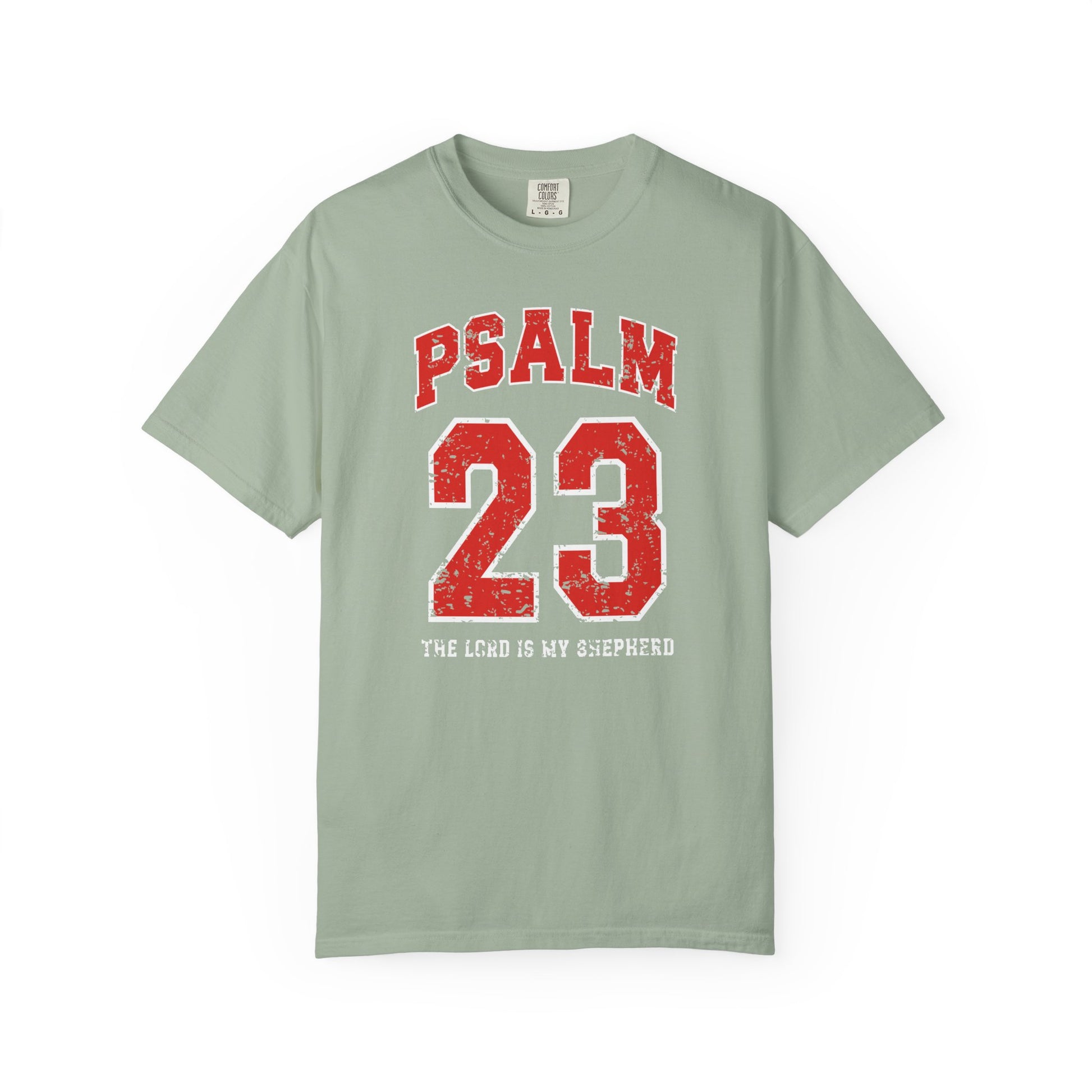 On the front side of this custom vintage t-shirt are the words Psalm 23 The Lord Is My Shepherd, it is with red and white block lettering.