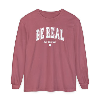 On the front of this custom unisex long sleeve shirt are the words Be Real in large bubble font with the words not perfect underneath the bubble letters, on the bottom there is a heart.