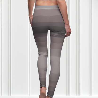 Custom high waisted women's leggings that have a wavy lines pattern that are all different shades of grey.