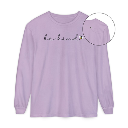 On the front of this custom unisex long sleeve shirt are the words be kind in a simple cursive font, with a bumble bee on the right side of the letter kind, on the back right shoulder there is an image of a bumble bee flying and leaving a trail behind it in the shape of a heart.