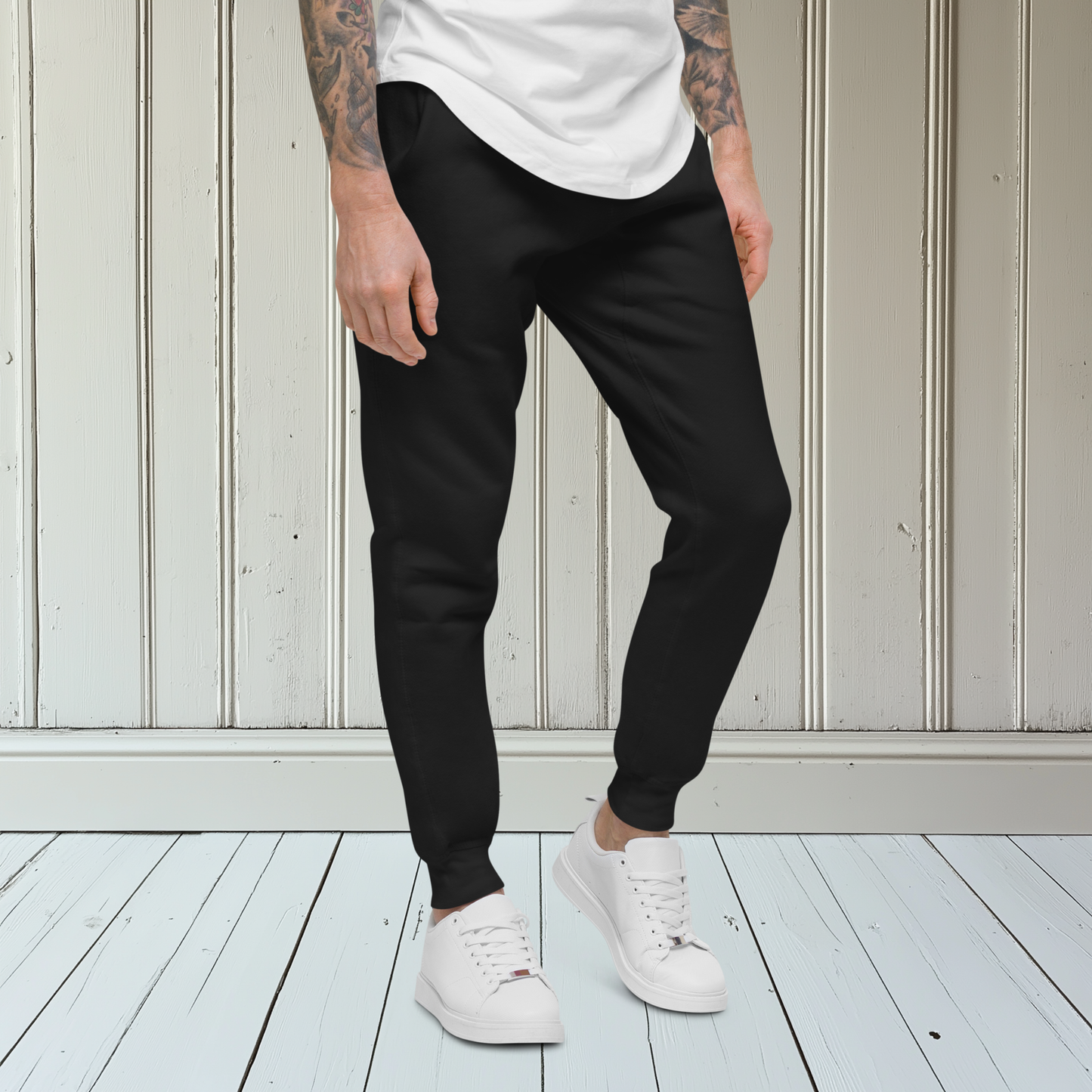 A pair of super soft custom unisex fleece sweatpants with a male lion head on the back calf of the right leg embroidered in silver.