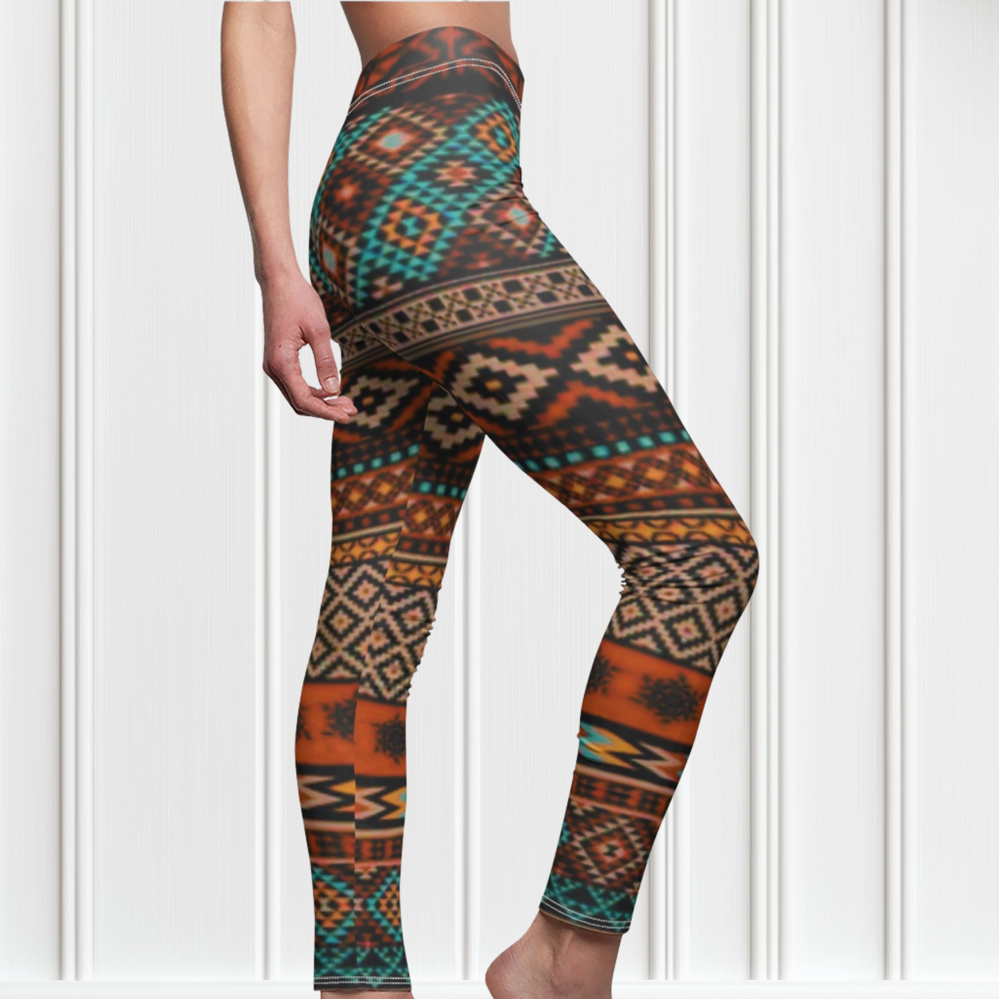 A pair of super soft handmade women's ankle length high waisted leggings. The pattern throughout the entire pair of pants is a orange, brown and blue Aztec pattern from the top of the pants to the bottom of the leggings.