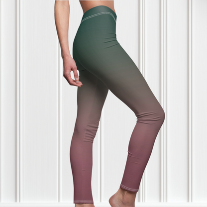 A pair of custom handmade high waisted women's leggings with an ombre pattern that starts as an emerald green at the top then fades to a light purple, then to a deep purple at the ankle of the pant.