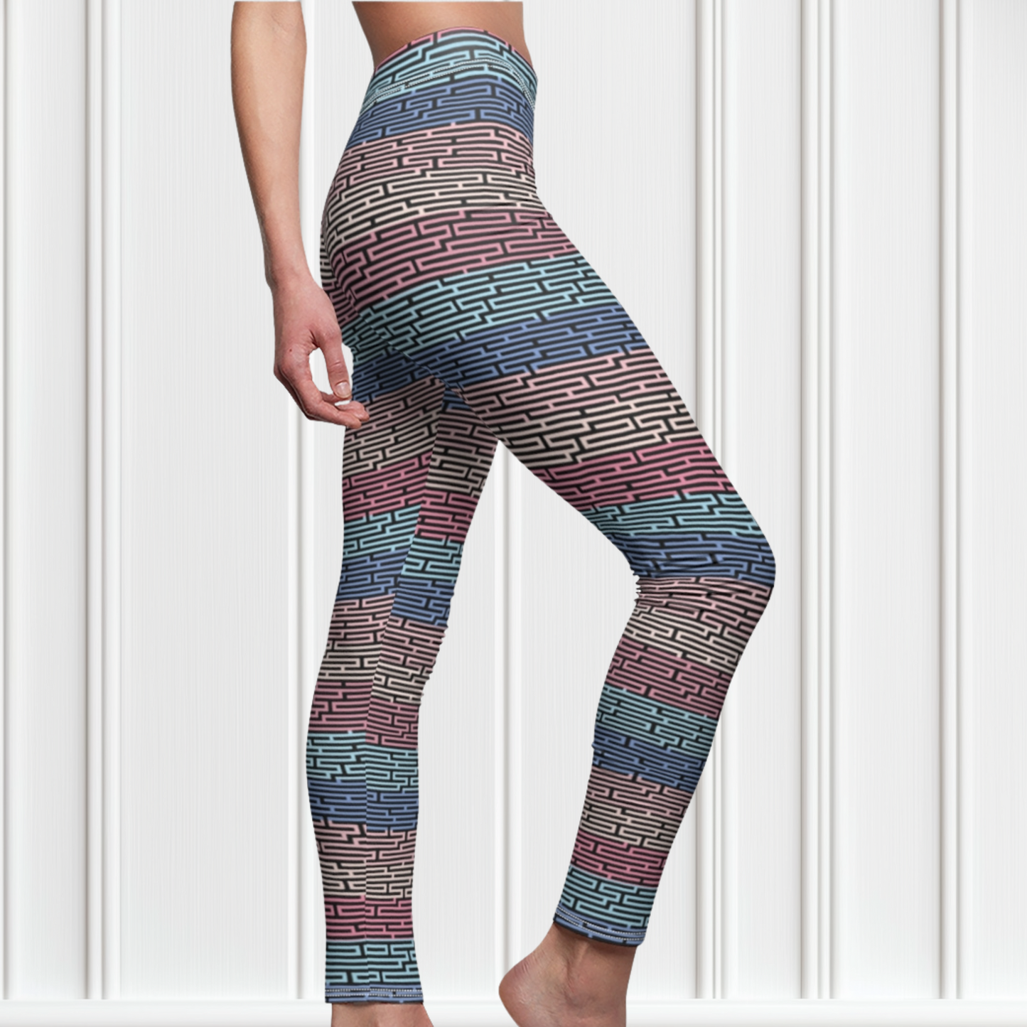 Custom women's high waisted leggings with rows of pastel red, yellow and blue from the top to the bottom of the leggings, there is a black abstract pattern overtop of the colors giving the leggings a 3D look.